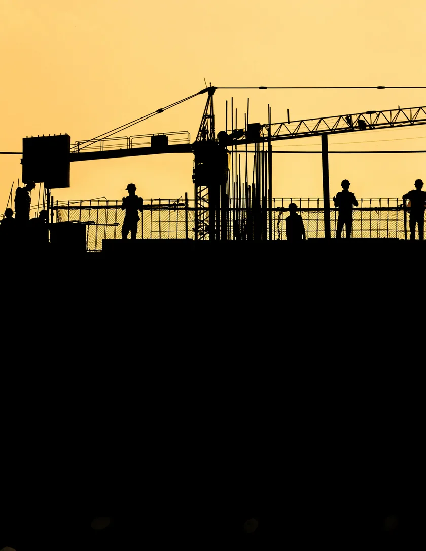 A crane silhouetted against a sunset.
