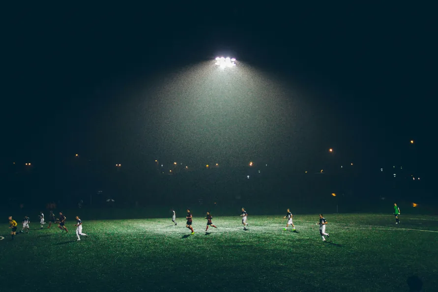 A floodlit pitch at night.