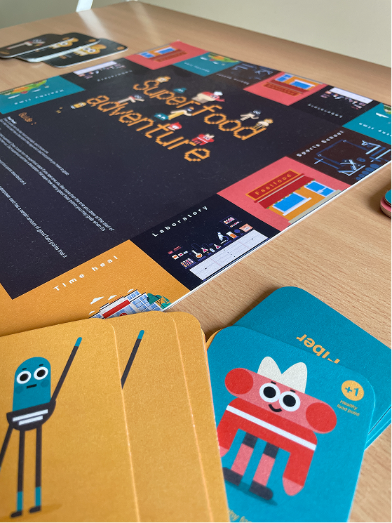 The Superfood Adventure board mid-game, with card decks fanned out across it.